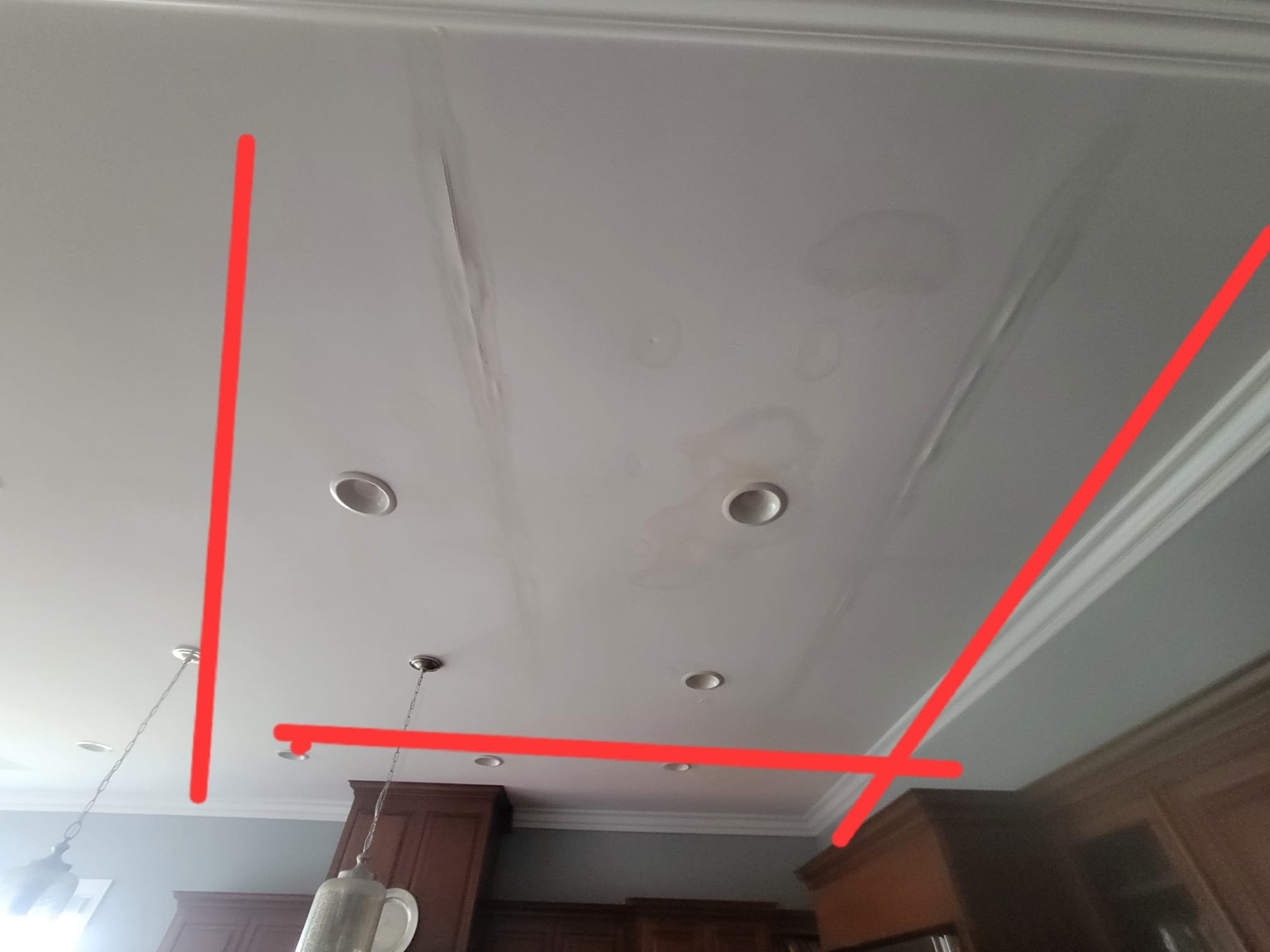 Water-damaged kitchen ceiling before restoration.